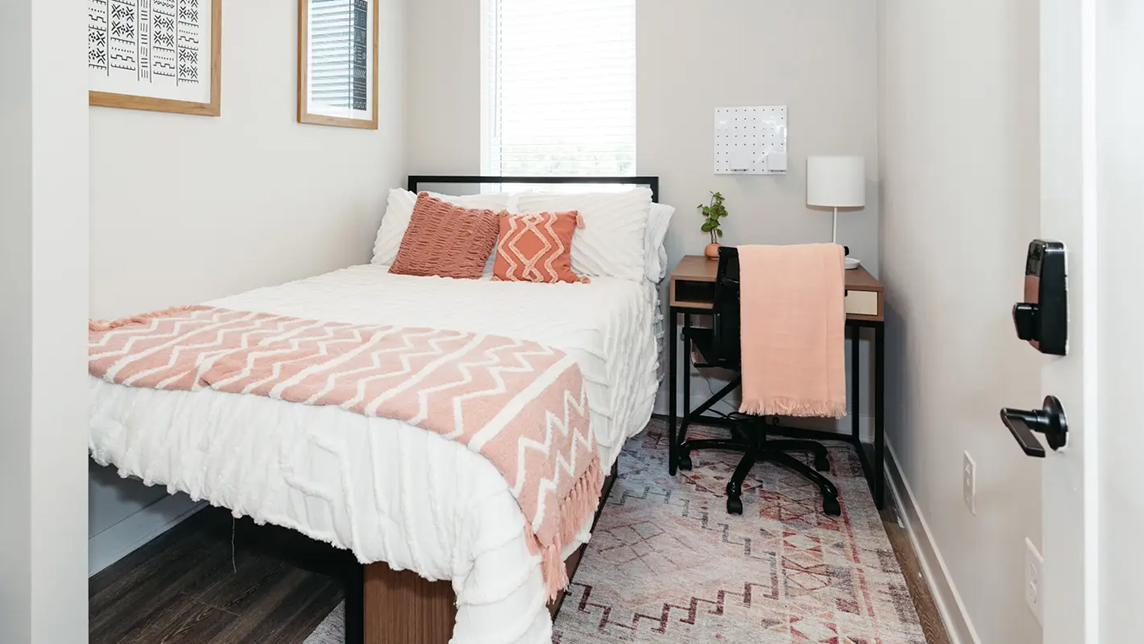 Furnished bedroom with desk and chair